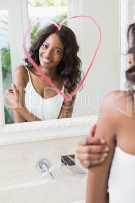 Beautiful young woman looking in the mirror