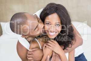 Young man kissing woman on her cheek