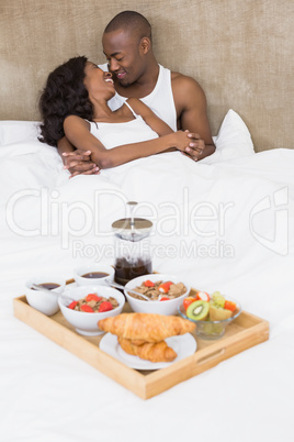Young couple cuddling on bed