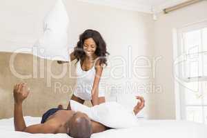 Young couple having a pillow fight