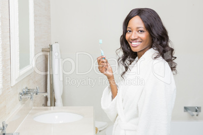 Portrait of a young woman holding tooth brush