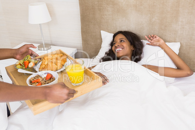 Man serving breakfast to woman