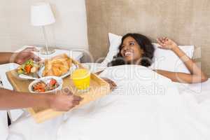 Man serving breakfast to woman