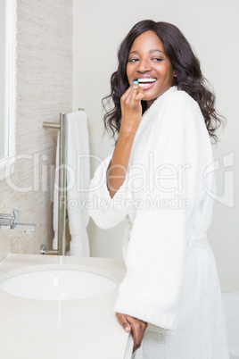 Young woman brushing her teeth