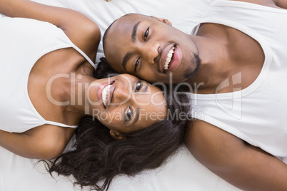 Portrait of young couple lying on bed