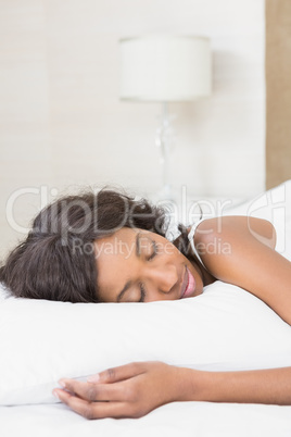 Beautiful young woman lying on bed