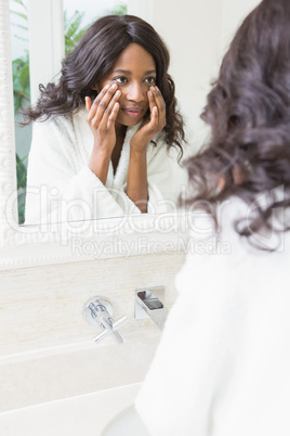 Woman checking her skin in bathroom