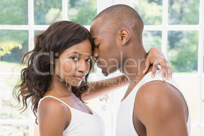 Young couple standing face to face and hugging each other