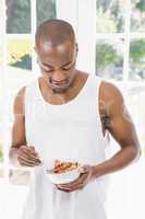 Young man having breakfast cereals