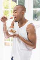 Young man having breakfast cereals