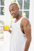 Portrait of young man holding glass of water