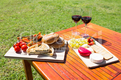 Fruit, bread and wine glass on wooden table