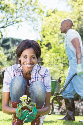 Young woman holding a sapling