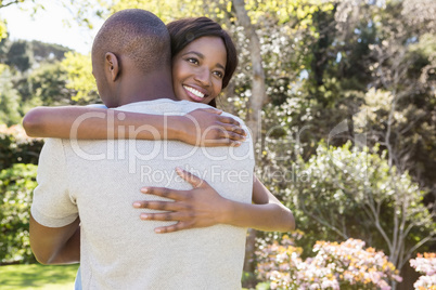 Young couple hugging in park