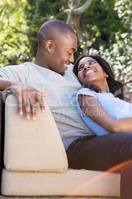Young couple relaxing on the sofa and looking face to face