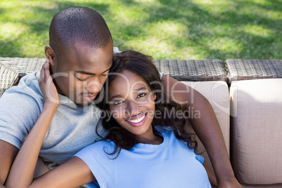 Young couple relaxing on the sofa and using digital tablet