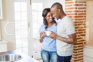 Young couple holding coffee mug