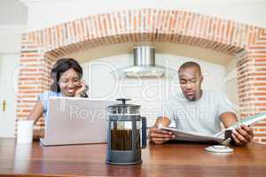 Young woman using laptop in the kitchen