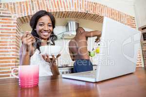 Young woman having breakfast in the kitchen