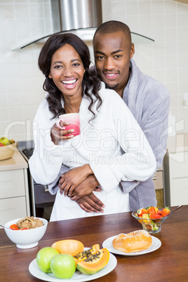 Young couple cuddling in the kitchen