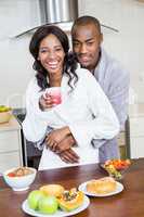 Young couple cuddling in the kitchen