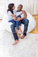 Young couple relaxing on the bean bag