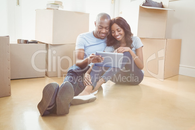 Young couple using digital tablet