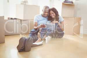 Young couple using digital tablet