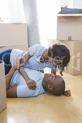 Young couple cuddling in their new house