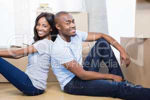Young couple sitting together on the floor and smiling