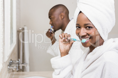 Young couple brushing teeth