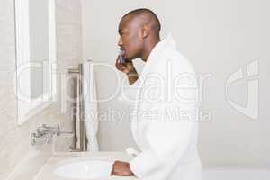Young man brushing his teeth