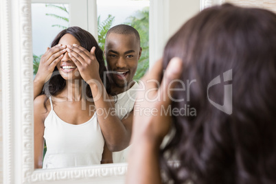 Young man covering womans eyes