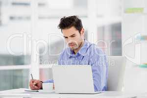 Businessman writing in diary