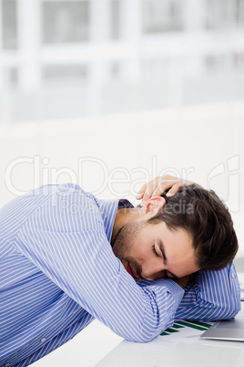 Businessman putting his head down on desk