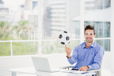 Businessman spinning a football on his finger