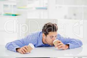 Businessman having coffee from disposable cup