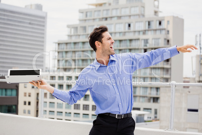 Frustrated businessman throwing laptop