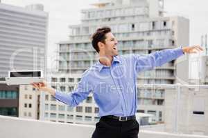 Frustrated businessman throwing laptop