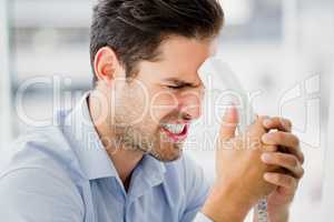 Frustrated businessman holding a telephone