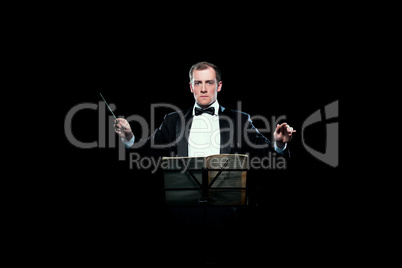 Studio photo of music conductor holding his baton