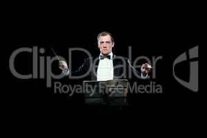 Studio photo of music conductor holding his baton