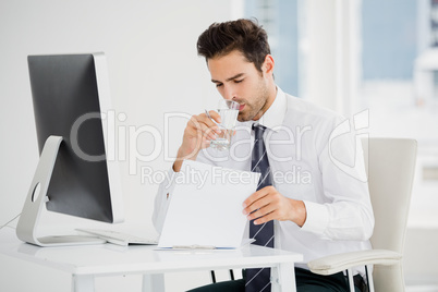 Businessman having a glass of water