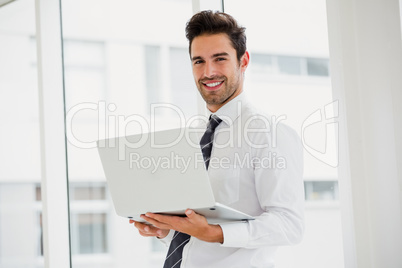 Businessman using laptop and taking notes