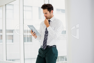 A businessman is holding and reading a notebook