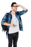 Young man carrying rucksack and holding camera