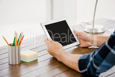 Man holding digital at his desk