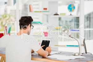 Young man using digital at his desk