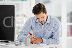 Businessman taking notes at his desk