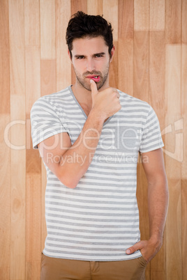 Handsome man posing in front of wooden background